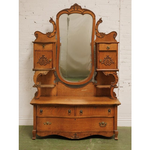 The Tiger Oak French Antique Dresser boasts a rich, golden-brown patina with dramatic, flame like grain patterns,...