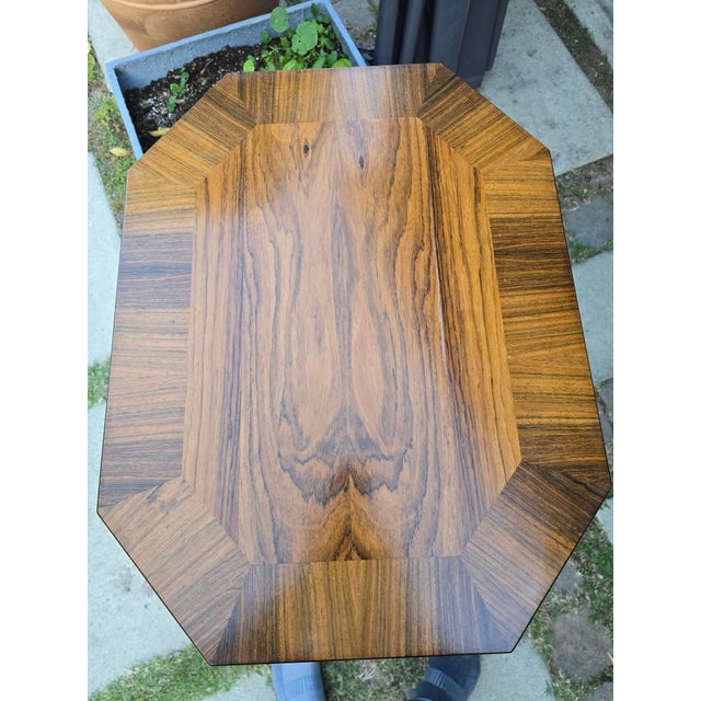 This is a versatile accent table that could work in any room in your home. The top is rosewood veneer and the legs are a...