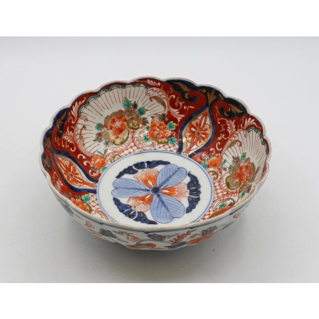 Circa 1860-80 round Imari scalloped edge bowl, Japan. Elegantly decorated with flowering vines on exterior & interior with...