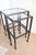 Contemporary pair of iron nesting table's. The frame is handcrafted from iron that is cast and forged by artisans to...