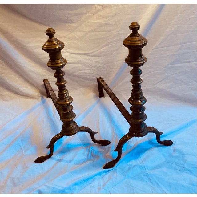 Well turned Edwardian Brass fireplace andirons with iron back stands into fireplace.