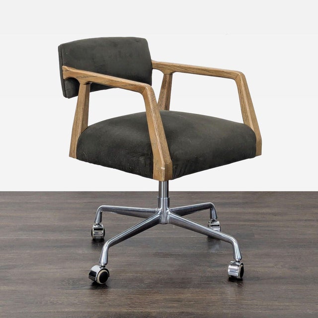 This Four Hands chair features a sturdy metal base with smooth-rolling casters, comfortable black cushioned seat and back,...