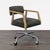 This Four Hands chair features a sturdy metal base with smooth-rolling casters, comfortable black cushioned seat and back,...