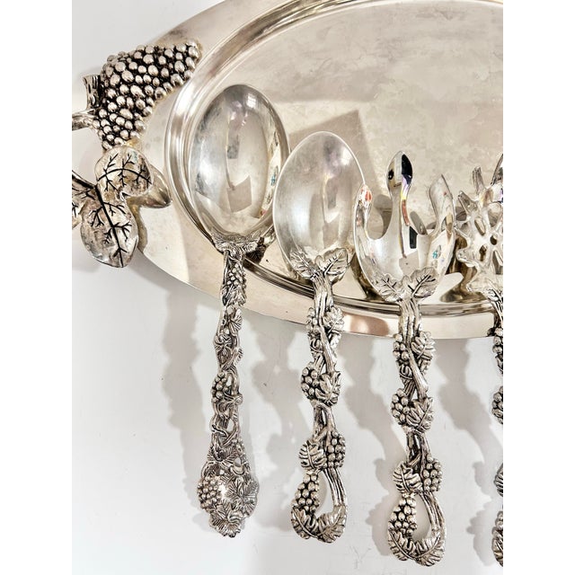 This elegant vintage serving set by Godinger features a richly detailed grape and vine motif, crafted in silverplate and...