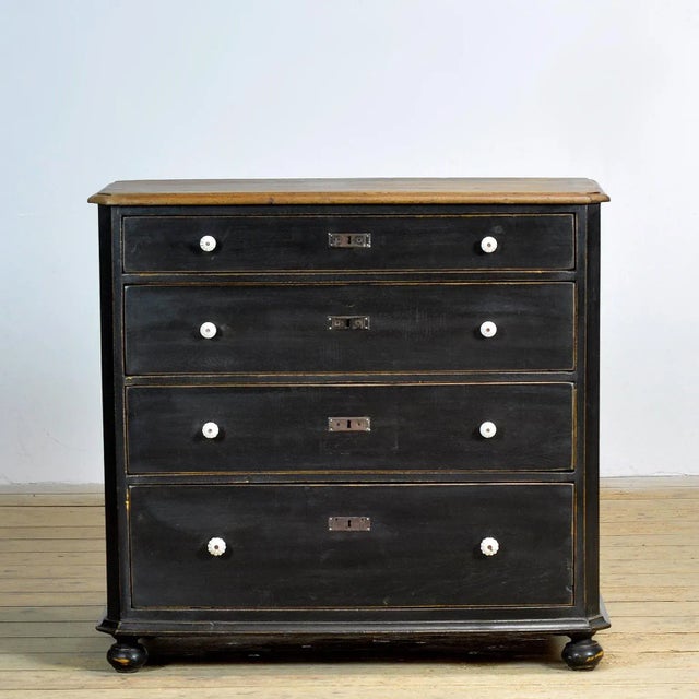 Chest of drawers made circa 1910 in Hungary. The chest is made of oak and pine. It has four drawers, all with dovetail...