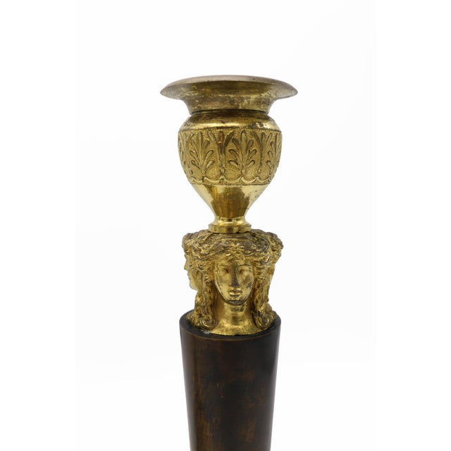 Pair of "Retour d' Egypt" candlesticks. Patinated Bronze shafts toped with fire gilt bobeches on top of figural Caryatids...