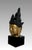 An eye catching golden image of Buddha mounted on a high quality black square pedestal. Identified as a depiction of...