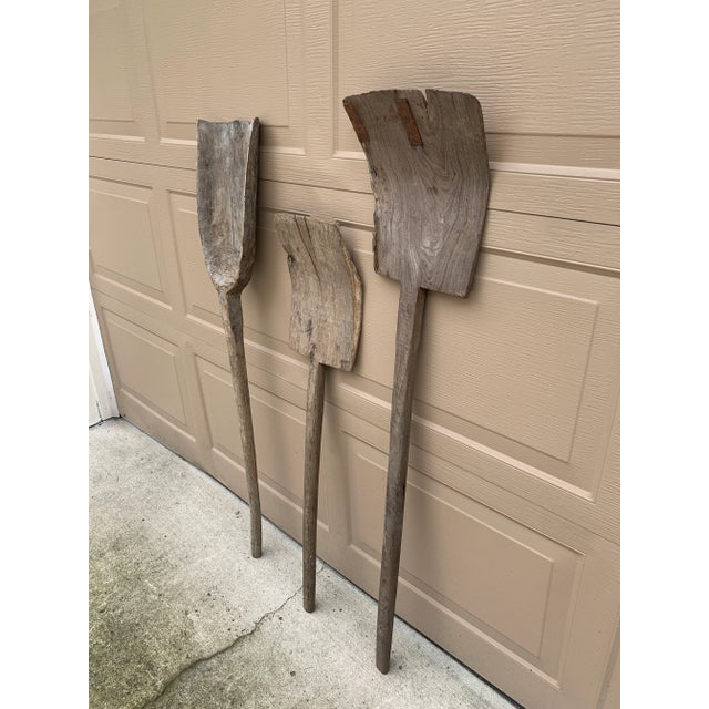 A wonderfully sculptural set of three late 19th century wooden garden tools, each hand-hewn with beautifully weathered...