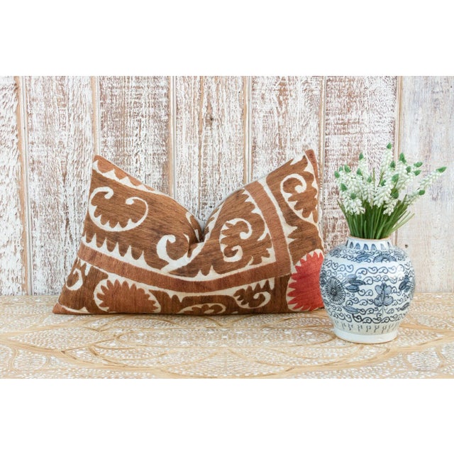 Made from a vintage Suzani tapestry, it features hand done embroidery and a solid linen back. Suzani is a Persian word...