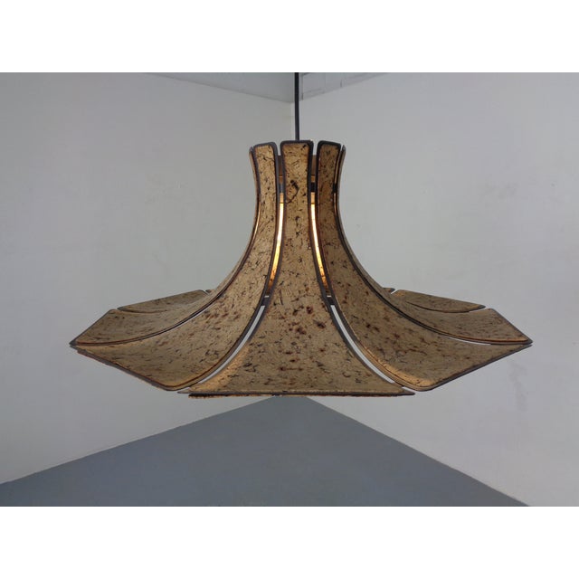A ceiling lamp made of metal and cork, dating from the 1970s. Up to 250V (Europe/UK Standard).The wiring of this item may...