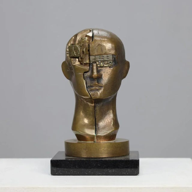 Raf verjans. bronze sculpture titled homo decessor, where human vulnerability and technological progress converge. The...