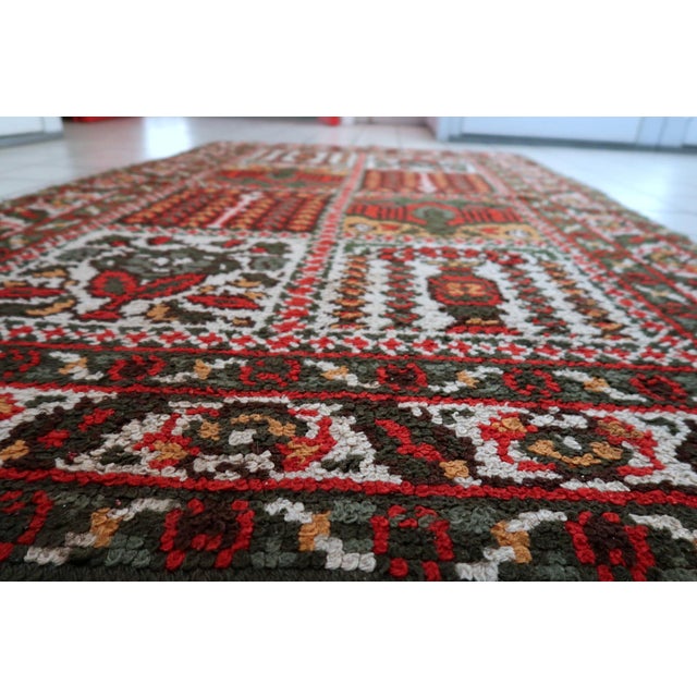 A sophisticated and charming hand-loomed French Savonnerie style rug dating to the mid-20th century (1950s). This piece...
