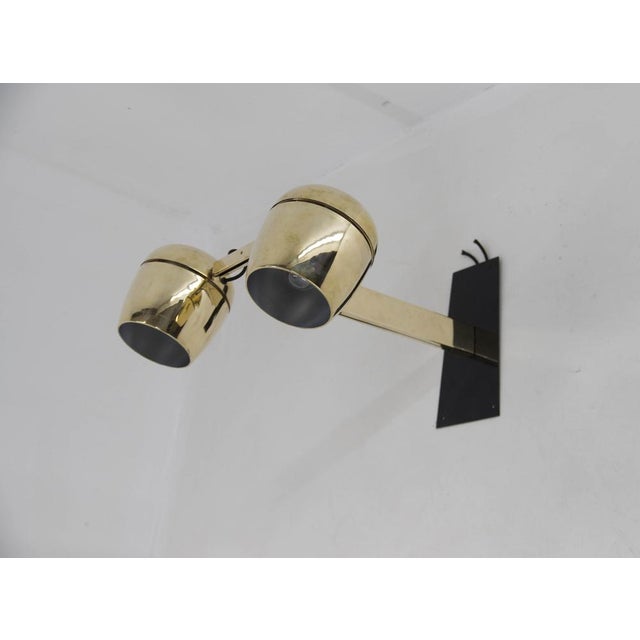 Big wall lamp with two adjustable shades made of polished brass. Made in czechoslovakia by napako in 1970s in brutalist...