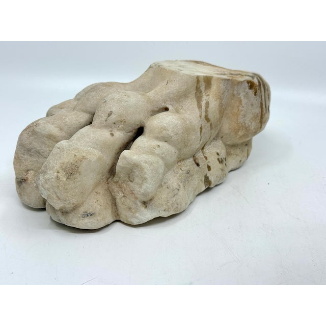 Possibly classical or later, carved stone fragment in the form of a stylized lion’s paw or foliate terminal, likely from a...