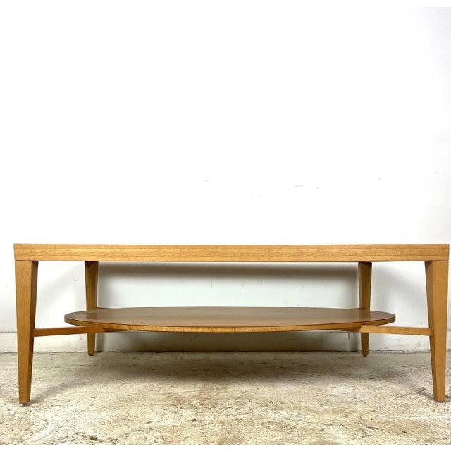 Wood and glass 2-tier table from Bernhardt Design. Beautiful design details with beveled edge on solid wood top, quarter...