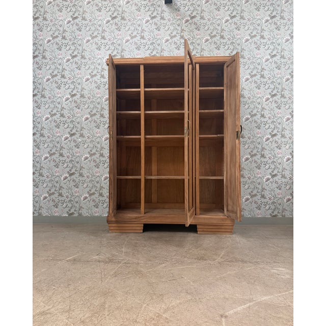 Elegant and commanding, this large art deco wardrobe captivates with its balanced lines, sculpted motifs, and wide beveled...