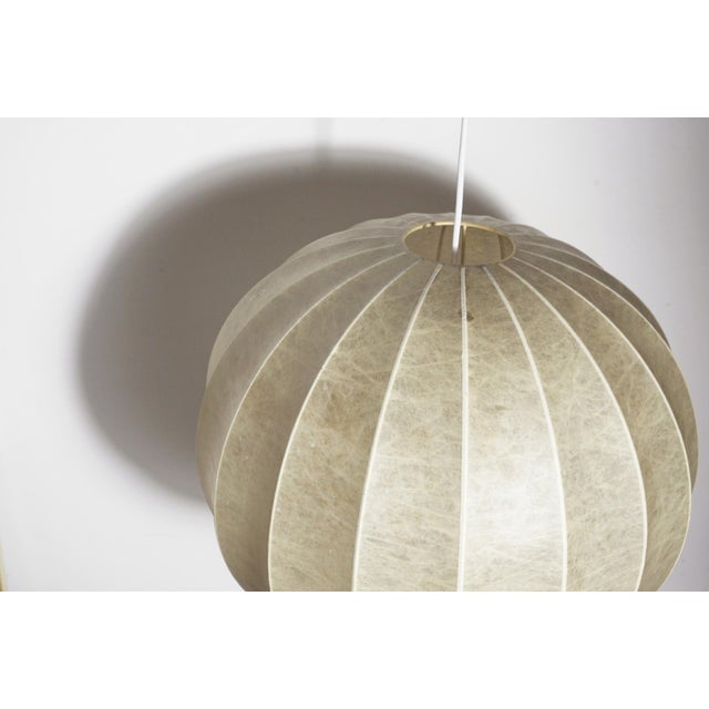 Italian cocoon création pendant lamp from the 1960s, white cocoon-resin globe over a ribbed metal frame. produced in italy...