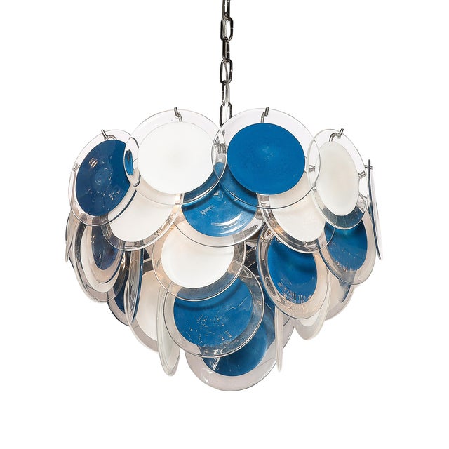 Illuminate your space with the breathtaking Modernist Four-Tier Murano Glass Disc Chandelier, which originates from Italy...