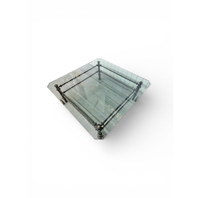This striking Giacometti-style glass top coffee table blends sculptural artistry with refined modern design. Featuring a...
