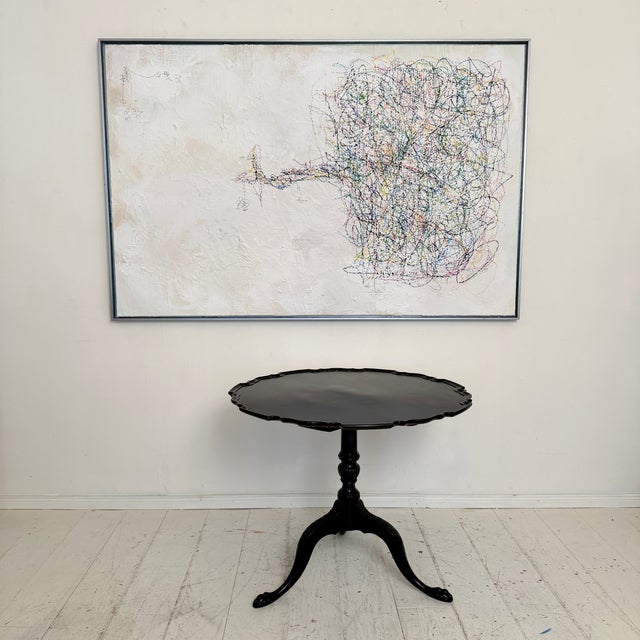 This elegant carved tripod pedestal side table was made in the 1940s in the Chippendale style and features a beautifully...