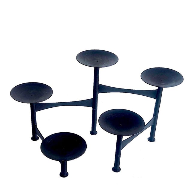 Offered is a sleek and chic articulating candelabra in a matte black finish on steel. It features 4 swinging arms topped...