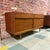 Vintage mid-century modern teak sideboard or credenza manufactured by Avalon of Yatton, UK. Features two upper drawers,...