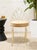 A charming vintage accent chair featuring an airy brass-tone metal frame with an elaborate scrolling backrest. Graceful...