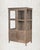 A cabinet that has held things. Books, brass vessels, folded clothes, the quiet accumulation of a life well-lived. This...