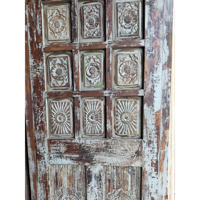 Infuse your space with timeless character using this vintage-style carved barn door, beautifully handcrafted from solid...