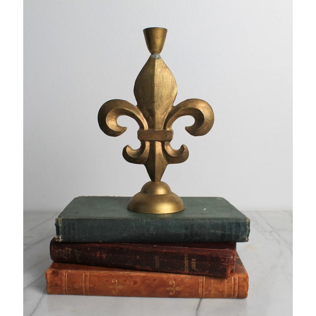 Vintage brass fleur-de-lis candlestick holder with a distressed metallic finish. No makers mark. Some patina.