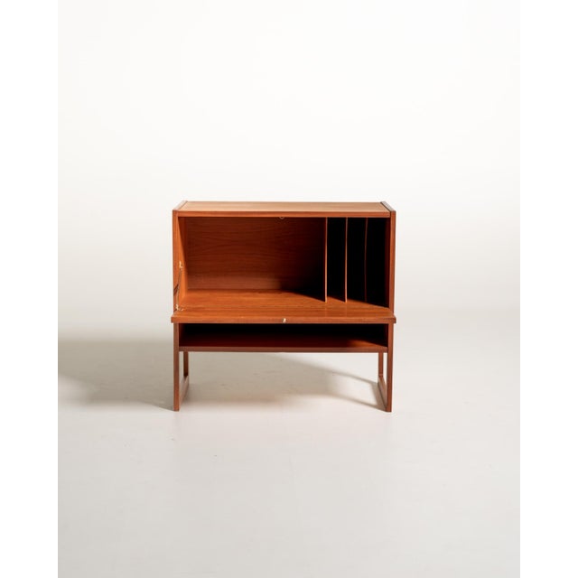 The "Domino" record cabinet designed by Arne Wahl Iversen in 1961. Made of teak, it features a drop-down door, an internal...