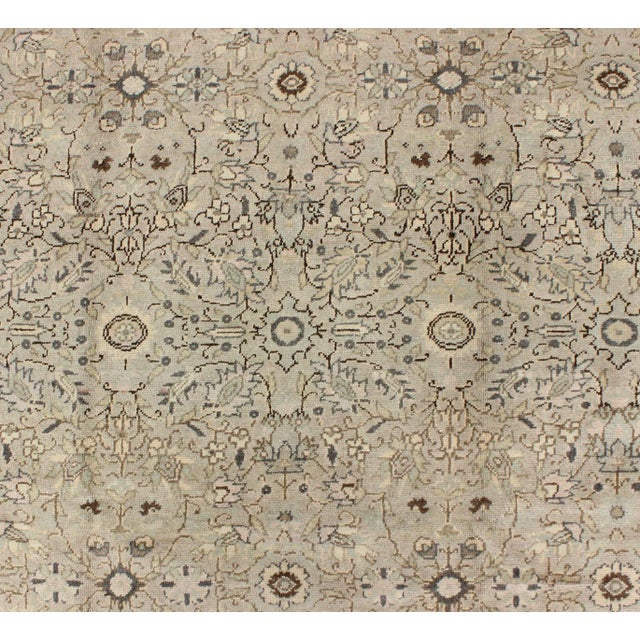 Measures: 5'9' x 8'2' In this early 20th century Turkish Sivas antique rug, the sand field features a delicate trellis...