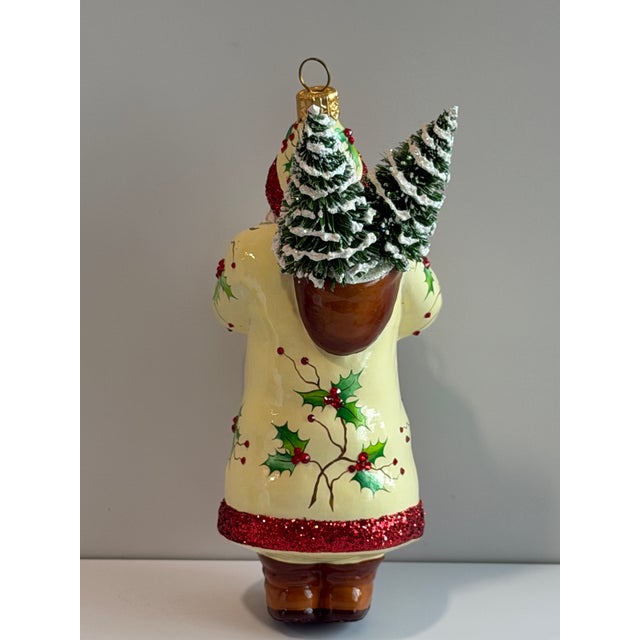 Patricia Breen “Holly’s” Santa collectible Christmas ornament featuring an elaborate Santa dressed in a cream coat...