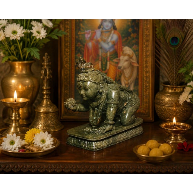 An extremely finely carved figure of Baby Krishna in natural serpentine stone, depicting the beloved Hindu deity in his...