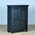 An atmospheric pine cabinet with a characterful, lived-in look. It features two doors with authentic escutcheons and a...