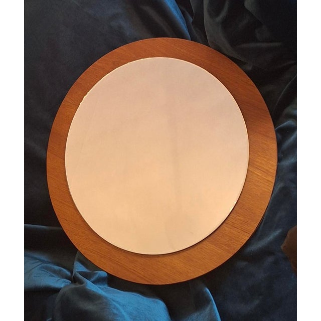 Mid century circular teak wall mirror, Denmark 1960s. Fine, narrow bevelled edge. (Light reflections on the bevelled edge,...