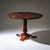 Center table with a circular top featuring a radial veneer pattern, raised on a tapered column with accent rings and a...