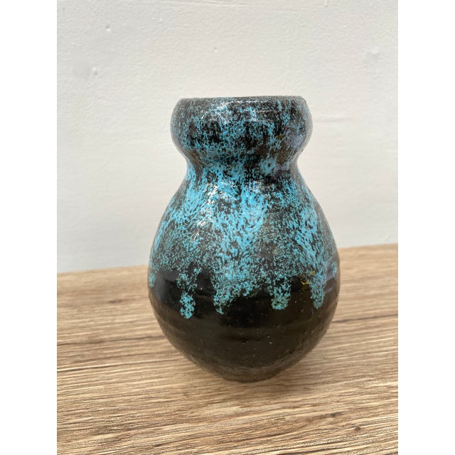 Elegant chamotte clay vase with a generous body and a narrow neck, finished with a thick, rounded lip. The piece is...