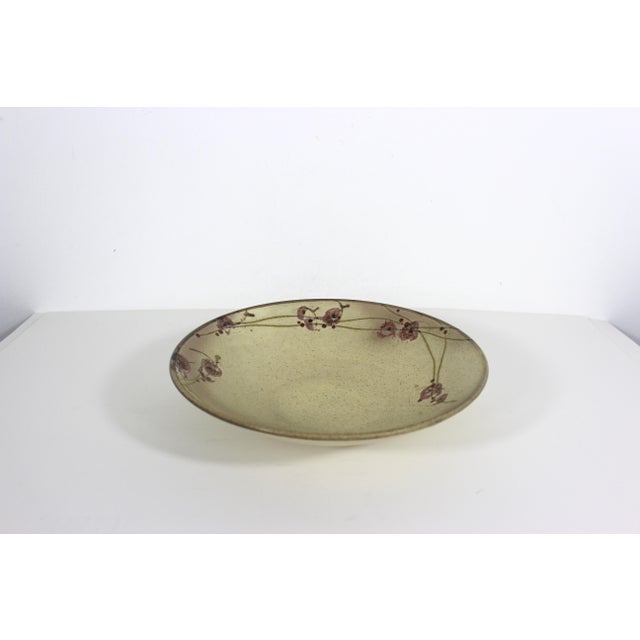 Vintage pottery serving bowl. The colours are earthy speckled tan with rose pink red details. Very useful size for salad,...