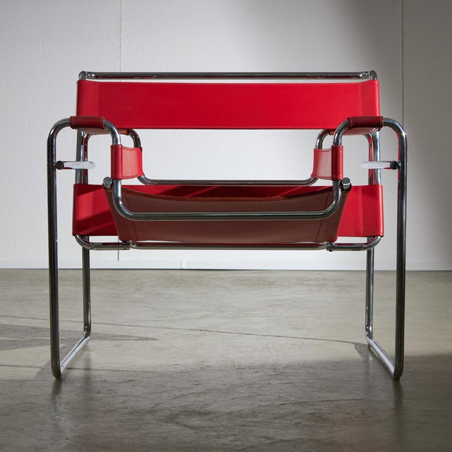 Introducing the Wassily Chair, a well-known piece designed by Marcel Breuer. This chair is available in a bright red...