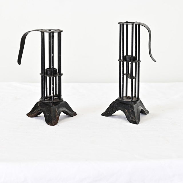 French 19th century (or earlier) forged iron carriers for a taper candle within a small cage. Extending from the rods at...