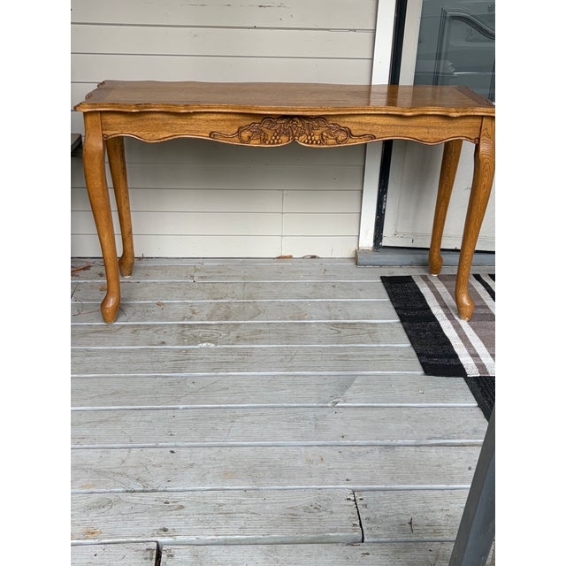 Oak table with center design and scalloped edge. Use as a console or desk