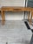 Oak table with center design and scalloped edge. Use as a console or desk