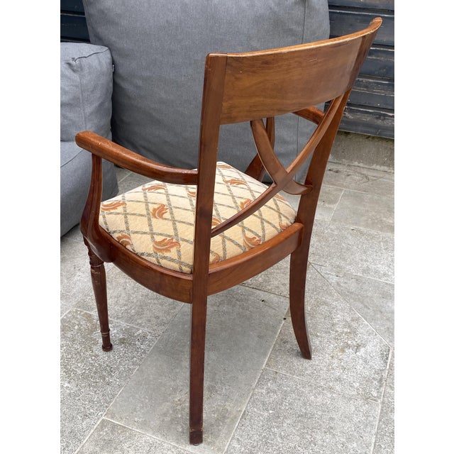 Upholstered seat in a beautiful, thick fabric in very good condition. Cherry wood frame with some signs of wear and minor...