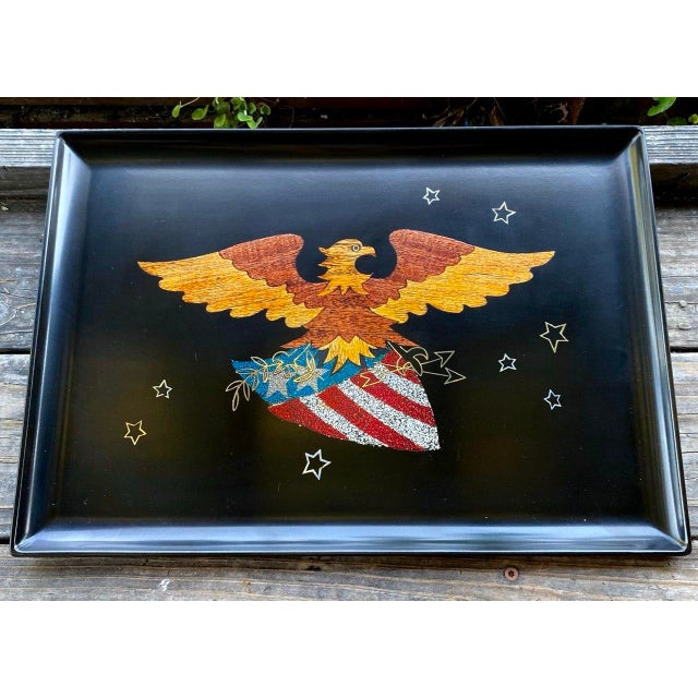 A striking vintage Couroc of Monterey serving tray featuring a majestic American eagle soaring above a patriotic shield...
