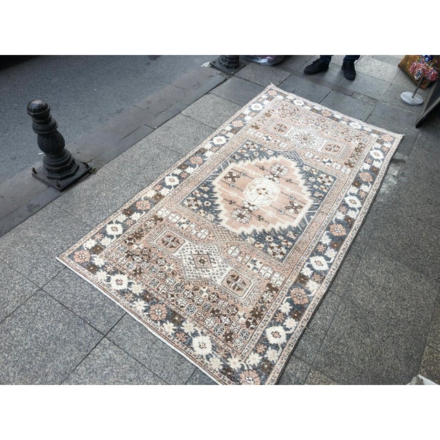 This is a vintage Turkish Oushak rug from the 1960s. The piece was hand-knotted.