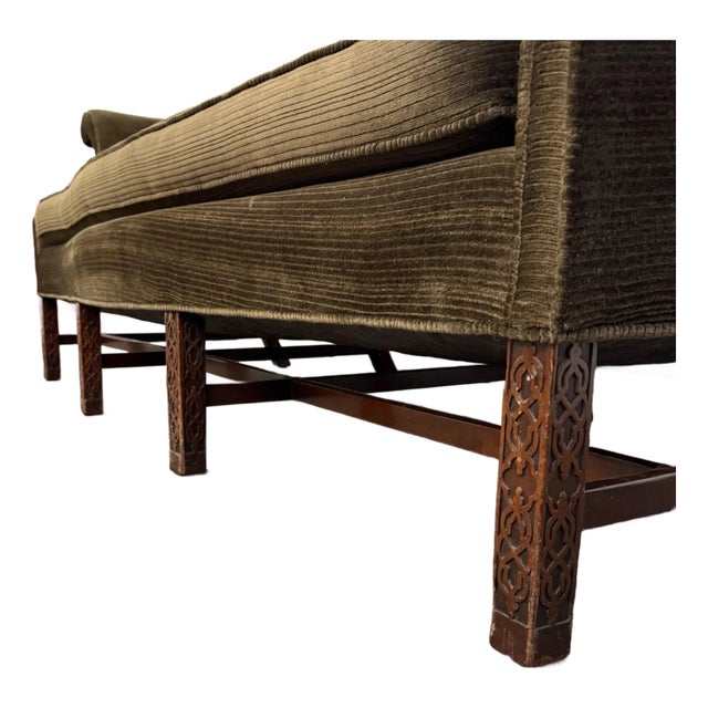 Antique English Chippendale Style Sofa. This sofa features carved wooden legs and a Georgia camelback style with brown...