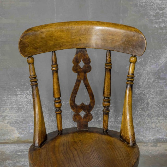 A very attractive set of four Late Victorian kitchen chairs made from Elm and beech. The top rail and splat back are...