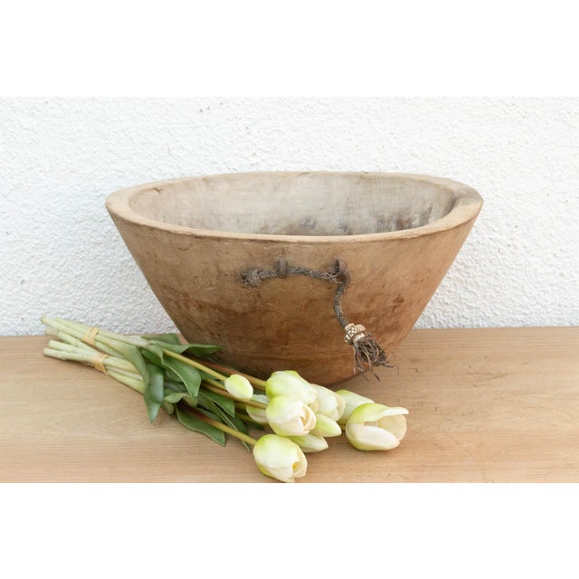 There is something deeply grounding about holding a vessel that was hewn by hand from a single block of wood. This antique...