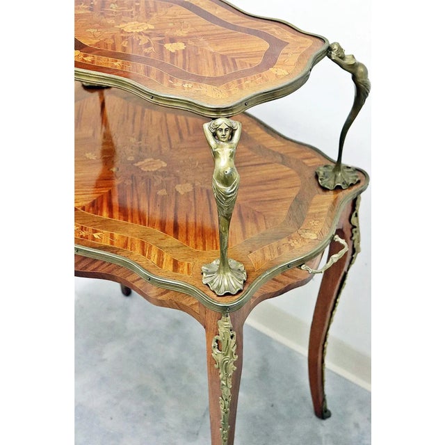 Sheer elegance in this 19c French double shelved tea table, covered in bronze trim, floral marquetry and parquetry...
